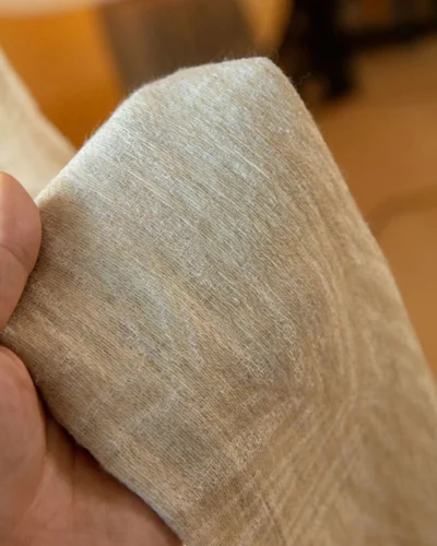 Oat Veil Sheer Curtain fabric swatch in hand, showing soft linen-like texture