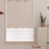 Rainbow Sprinkles Roman Shade with pom-pom trim in a bright, minimalist room