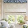 Tiny Tulip Jacquard Roman Shade in soft off-white with small blush tulip pattern, styled in a bright nursery window with a blue ruffle valance.