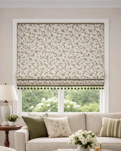 Beige patterned Roman shade in a living room, shown half lowered with tassel trim detail