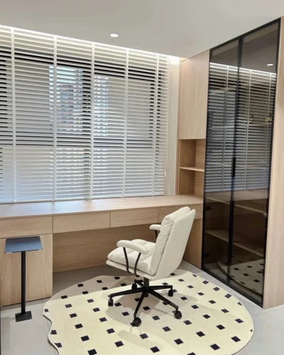 White venetian blinds in a modern home office with desk and chair
