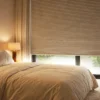 Blackout honeycomb blinds in bedroom with soft neutral interior and light control