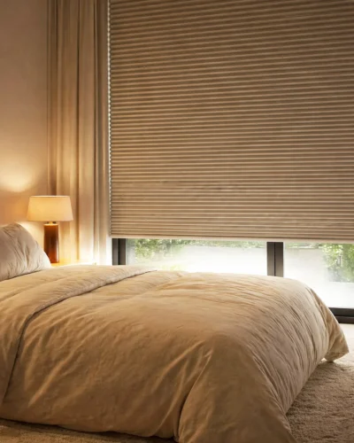 Blackout honeycomb blinds in bedroom with soft neutral interior and light control
