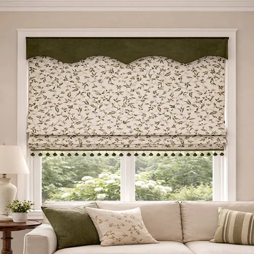 Beige patterned Roman shade fully raised with scalloped valance and tassel trim in a living room