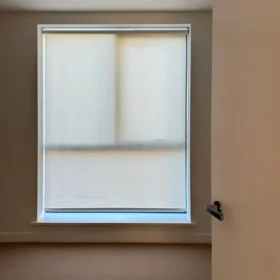Custom roller blinds in a modern living room with soft natural light