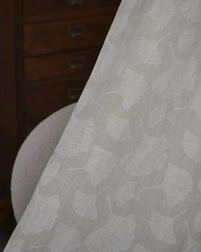 Close-up of ginkgo pure linen curtain fabric with natural botanical leaf texture