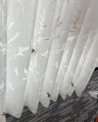 Amber Dragonfly Sheer Curtain close-up with embroidered dragonfly details and soft white textured fabric
