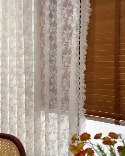 Close-up detail of Willow Lace Sheer Curtain fabric with botanical lace pattern