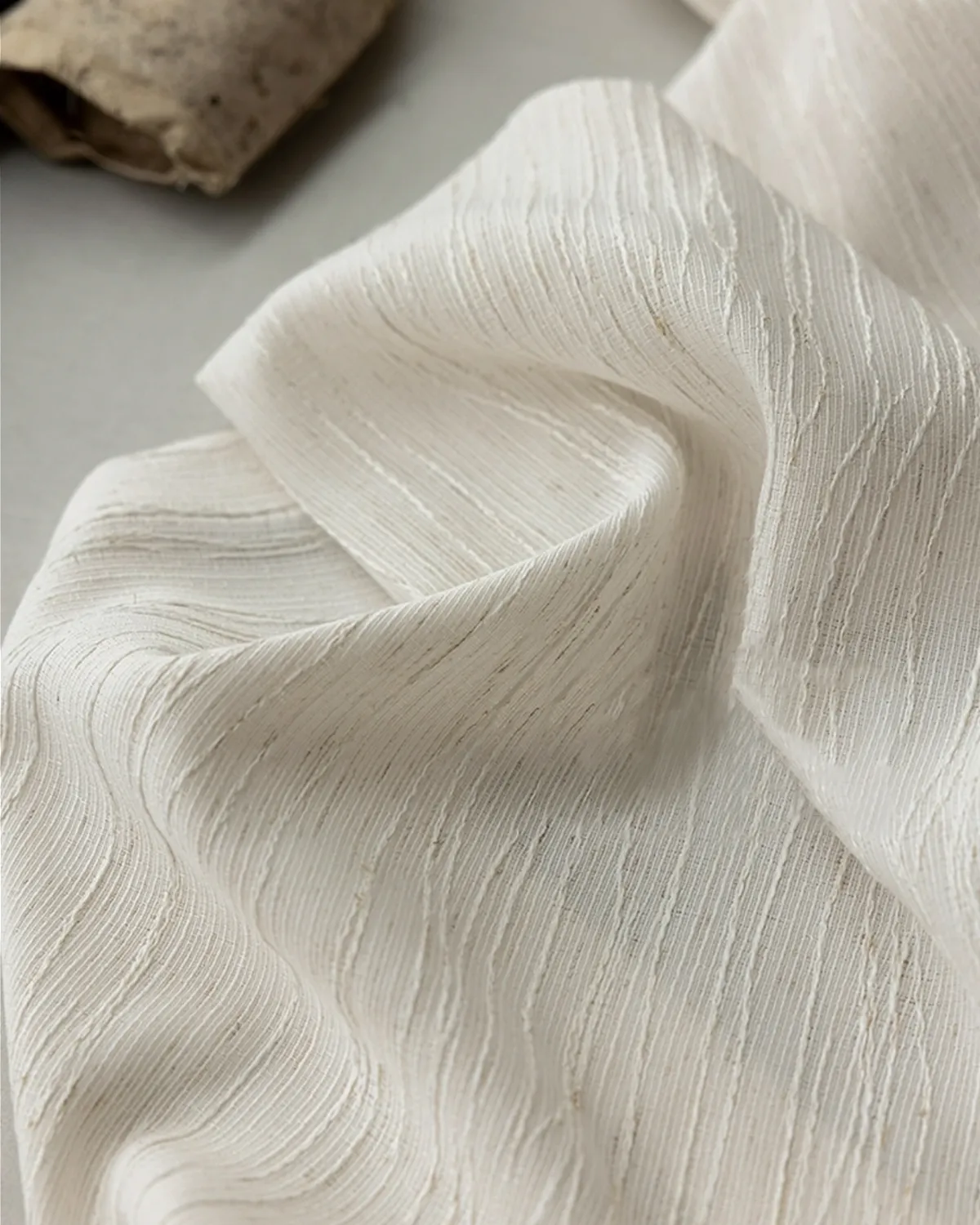Close-up detail of Oat Ripple Sheer Curtain fabric with soft vertical ripple texture