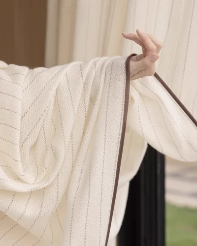 Mocha Pinstripe Sheer Curtain in a modern living room with soft light, subtle stripe detail, and elegant S-fold wave drape