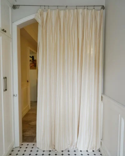 Cotton-rich linen texture curtain with golden stripes installed in doorway
