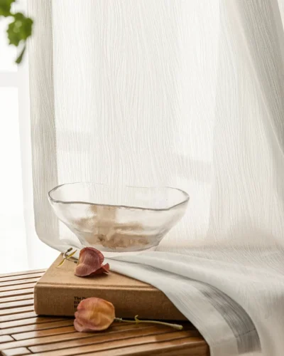 soft white linen texture sheer curtain beside a wooden table with natural light and home decor