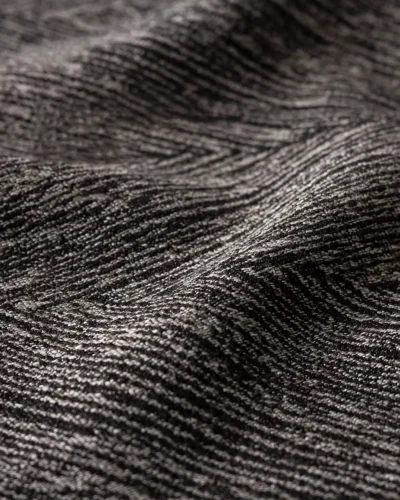 Charcoal Herringbone Blackout Curtain fabric close-up showing dark grey woven texture and refined herringbone pattern.