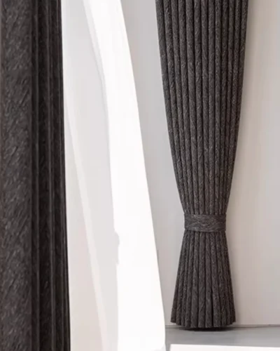 Charcoal Herringbone Blackout Curtain shown as full-length dark grey drapes with sheer curtain layering.