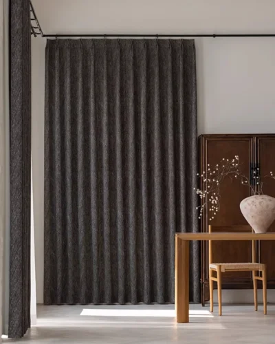 Charcoal Herringbone Blackout Curtain in a modern room with dark grey textured fabric and full-length window styling.