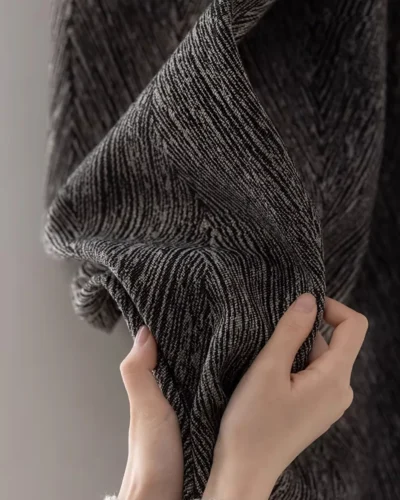 Charcoal Herringbone Blackout Curtain fabric close-up showing dark grey textured herringbone pattern and thick soft material.